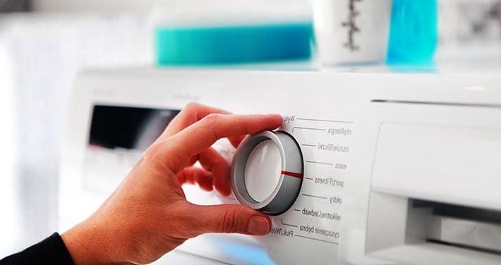 hand on dial of energy star washing machine